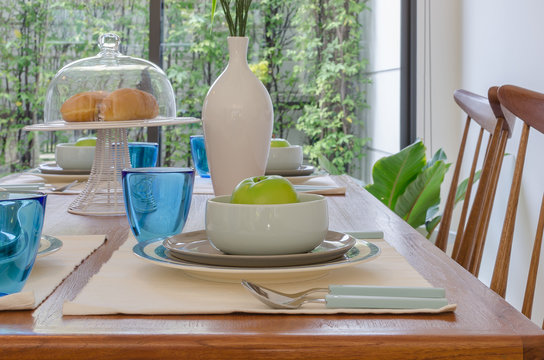 table set on wooden trable in modern dinning room