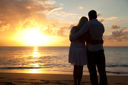 Silhouette of couple on a beach at sunset