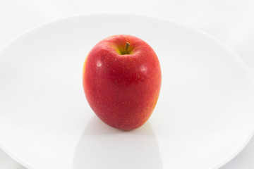 Red ripe apple on plate