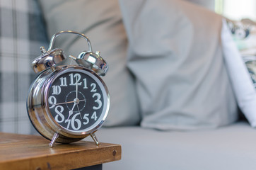 Classic alarm clock on wooden table