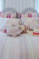 Fototapeta na wymiar colorful pillows on pink bed in luxury bedroom