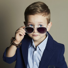 little boy in sunglasses.stylish kid in suit