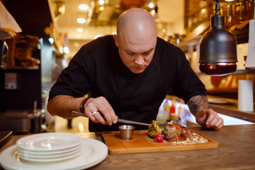 Chef in a black uniform jacket