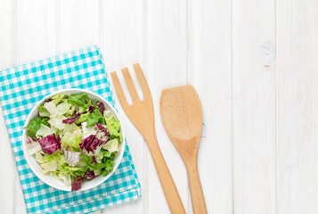 Fresh healthy salad over white wooden table