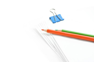 white office paper with clip and color pencil