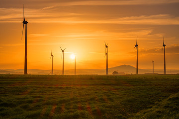 Several wind engines at sunset seen in Germany