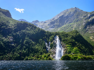Spectacular waterfall in Milford Sound fiord.