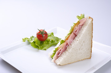 Ham and cheese sandwich with tomato and lettuce