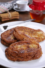 French toast on a plate, and bottom cinnamon, honey and coffee