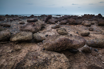 Rocky beach at sunset time