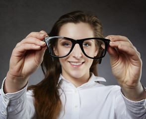 Smiling cute woman showing glasses