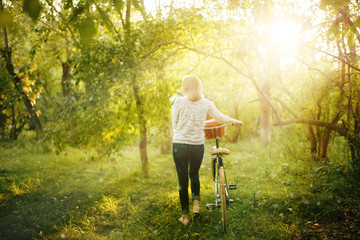 Blurred image of female with bicycle