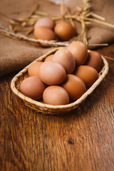fresh brown eggs and wheat on linen background