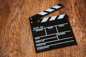 Movie clapper on wooden background