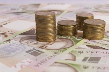 close up of pile of coins and hryvna bills