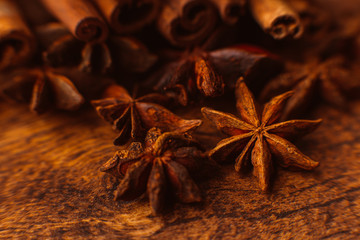 Cinnamon sticks with anise star on wooden background