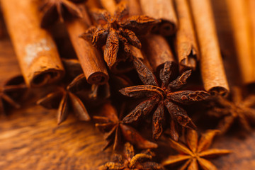 Cinnamon sticks with anise star on wooden background