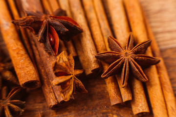 Cinnamon sticks with anise star on wooden background