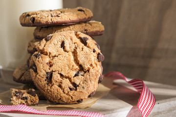 Pile of chocolate cookies with a glass of milk