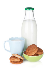 Cup, bottle of milk and bowl with cookies