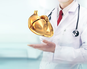 Doctor with stethoscope and golden heart on the  hands