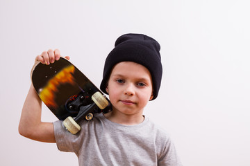 Young boy in a  hat and skateboard