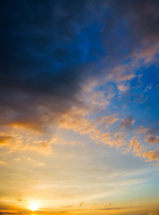 Naklejka na ściany i meble Stormy sunset with dramatic clouds on the horizon