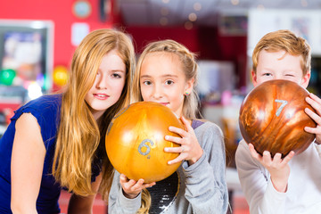Children Friends playing together at bowling center