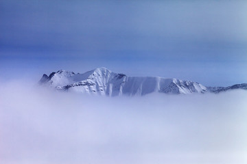 Snowy mountains in fog