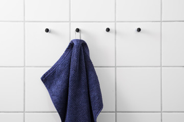 Blue towel white tiles