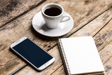 Fototapeta na wymiar Mock up set of smartphone, notebook and cup of coffee.