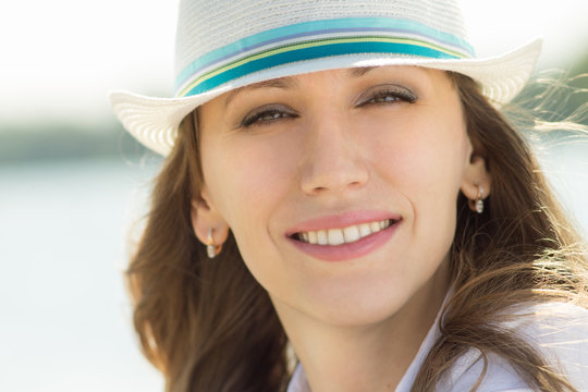 Young beautiful woman in white hat