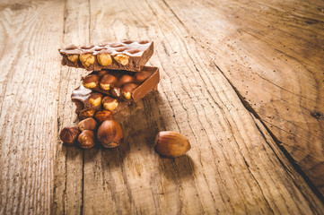 Chocolate and nuts on a wooden table in vintage style