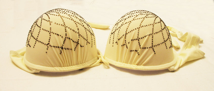 Light yellow bra isolated on the white background