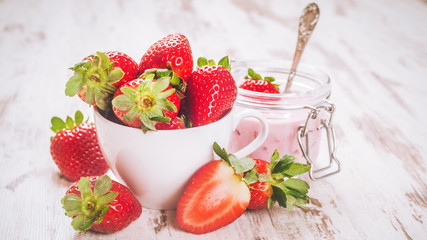 Spring fruits, strawberries with strawberry yogurt on a vintage