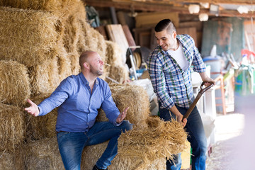 Two farm workers in hayloft
