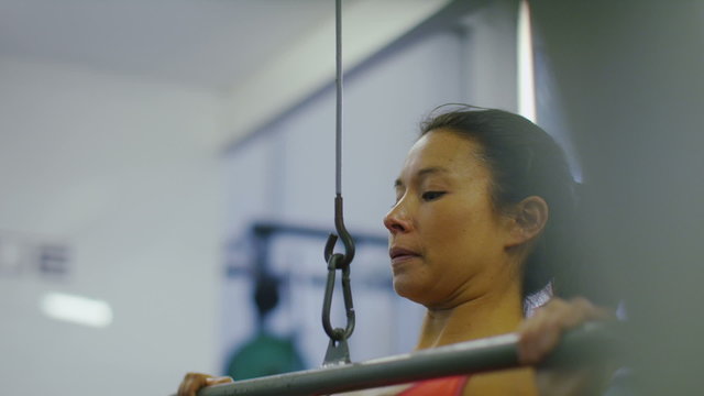 Attractive woman using weights machine in slow motion