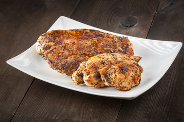 Grilled chicken breast on white plate