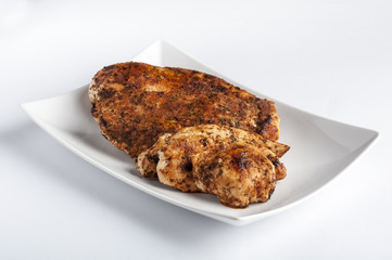 Grilled chicken breast on white plate