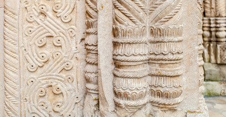 Ancient background texture with signs. Architecture part.