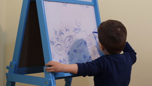 Child drawing on white board
