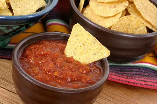 Mexican nachos with bowl of hot salsa Mexico food photo