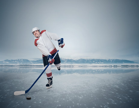 Aggressive Hockey player on the frozen Lake
