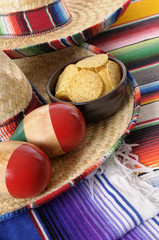 Mexican nachos with traditional rug or blanket sombrero maracas background Mexico food photo