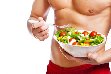 Fit man holding a bowl of fresh salad on white background