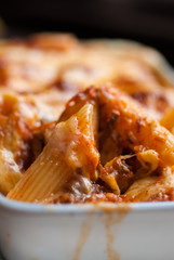 Baked penne pasta with tomato sauce and cheese