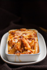 Baked penne pasta with tomato sauce and cheese