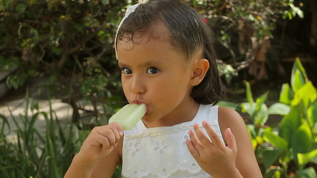 Hispanic Girl Eating Ice Pop Close Up
