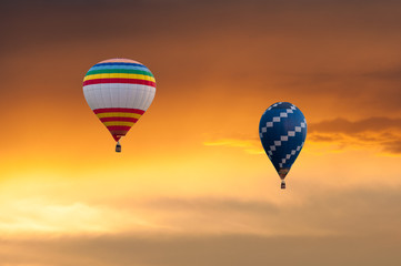 Two Hot Air Balloons in Flight on sunset sky background