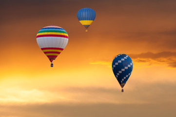 Three Hot Air Balloons in Flight on sunset sky background